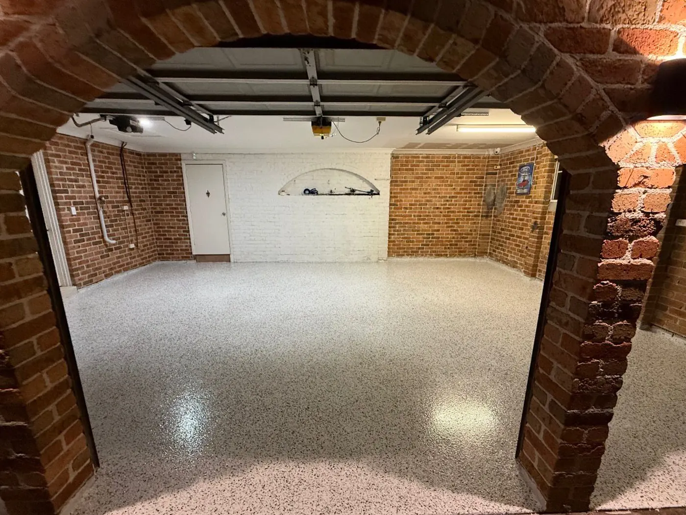 Decorative flake epoxy floor in a brick-arched basement garage — King of Seal Sydney
