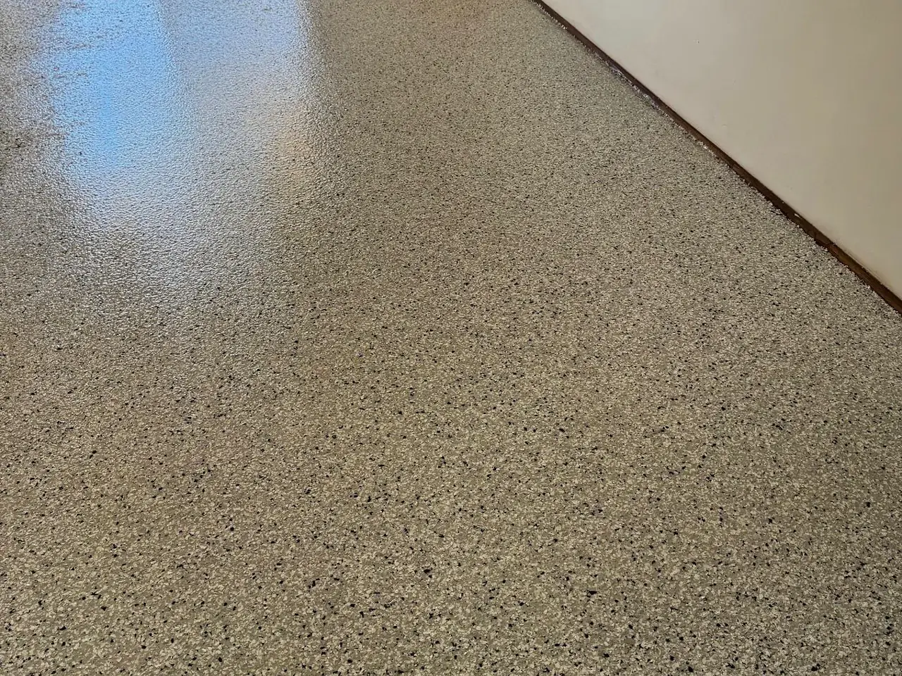 Salt-and-pepper flake epoxy floor in a residential room with sliding door — King of Seal Sydney