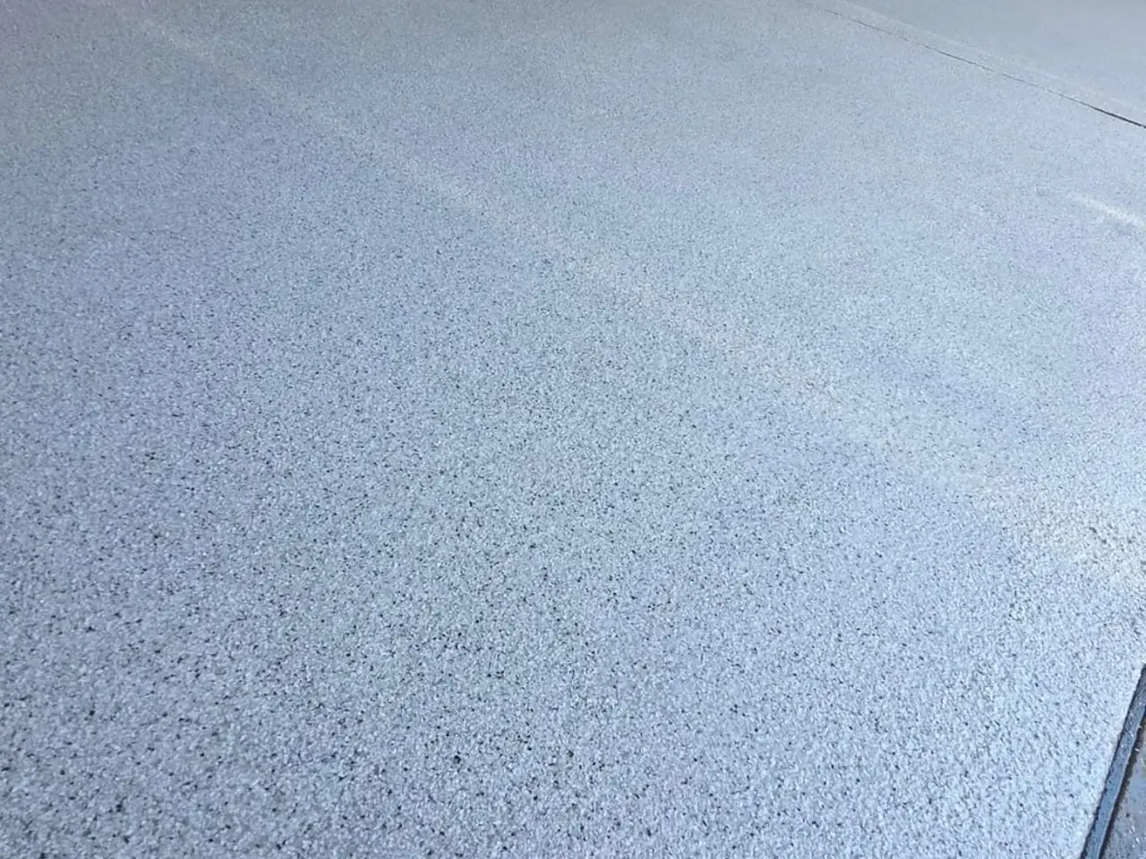 Light-grey flake epoxy garage floor with hot water unit — King of Seal Sydney