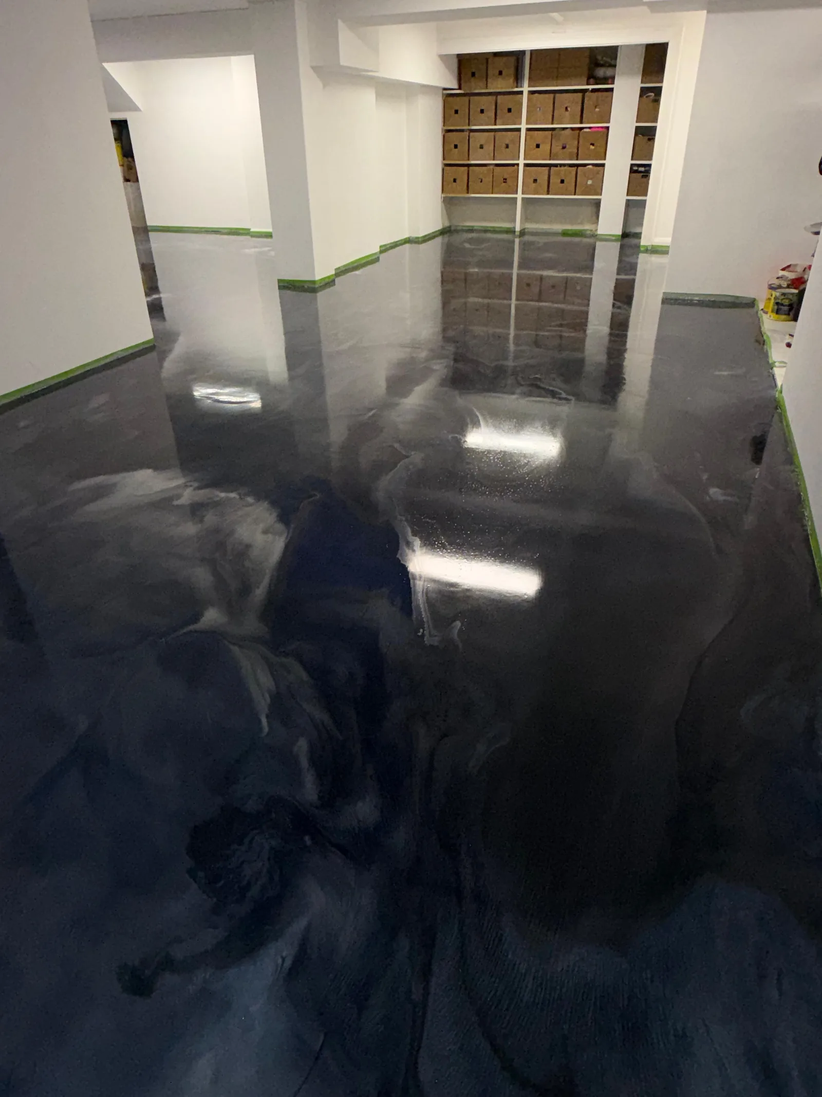 Black metallic epoxy basement floor with reflective swirl — King of Seal Sydney