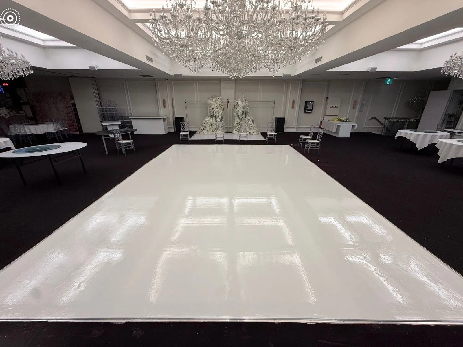 Wide view of high-gloss white solid colour epoxy dance floor with wedding chandeliers — King of Seal Sydney