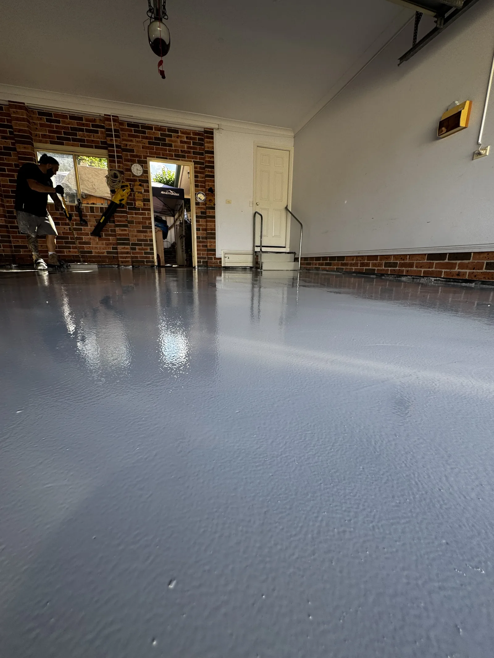Grey solid colour epoxy garage floor with brick interior — Eastern Suburbs Sydney