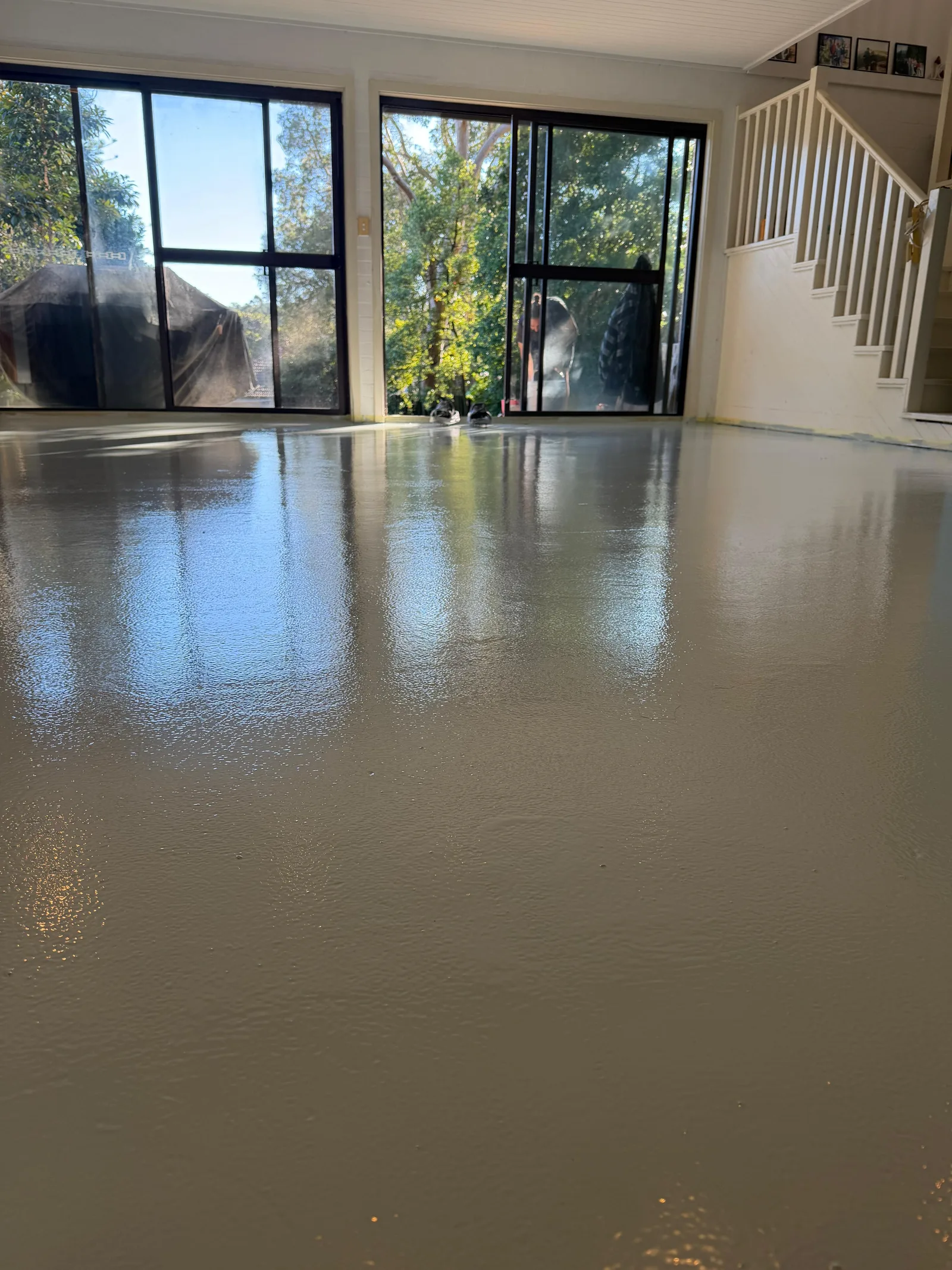 Light grey solid colour epoxy floor in residential living room — Chatswood, Sydney