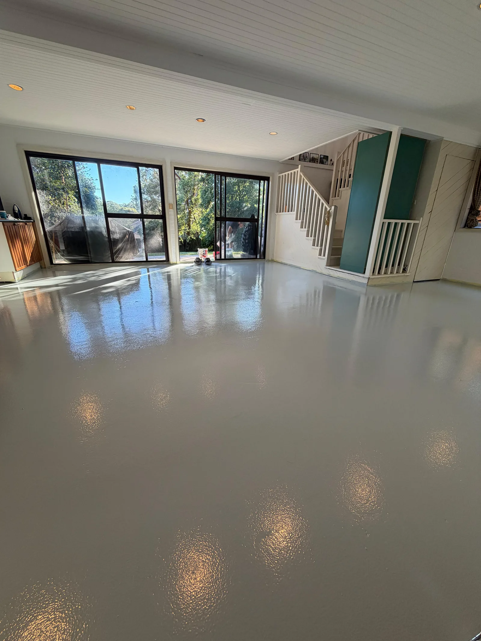 Light grey solid colour epoxy living room with stairs — North Shore Sydney